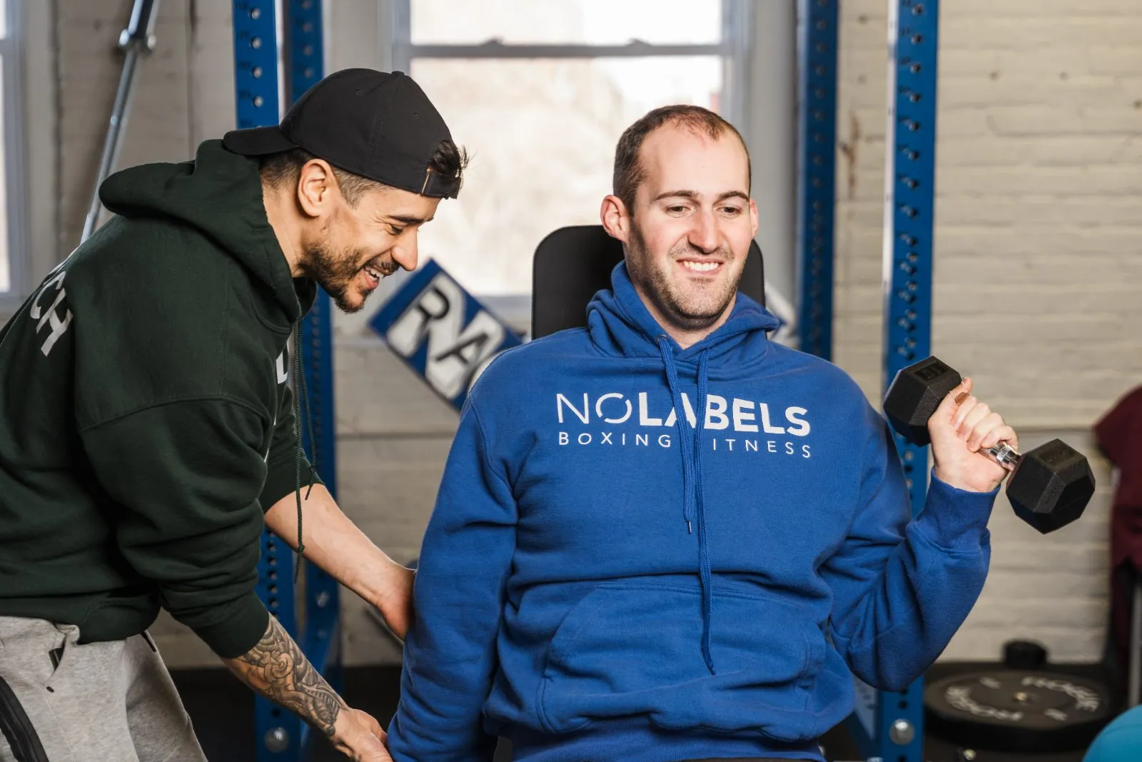 A coach cheering on an athlete doing dumbbell curls